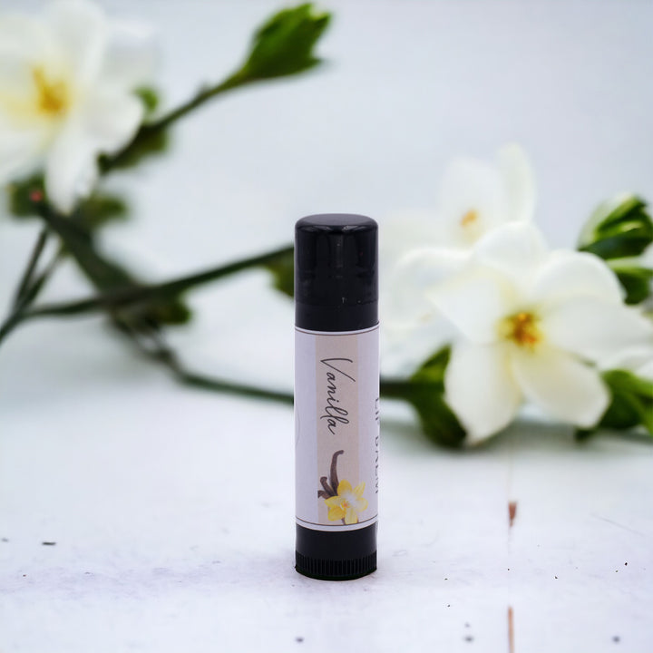 Vanilla Lip Balm, Classic Tube, Vanilla Flavored, Candle Cubby, Countertop Photo with Vanilla Flowers