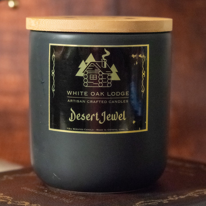 Desert Jewel, 12oz Jar Candle, Sandalwood Amber and Musk Scented, Front View on Old Books