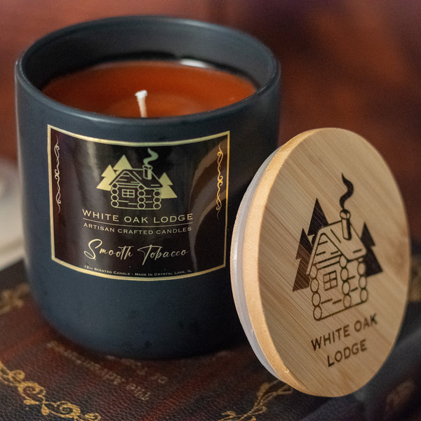 White Oak Lodge Smooth Tobacco Scented, 12oz, Stone Container, Candle with Lid open angled down.